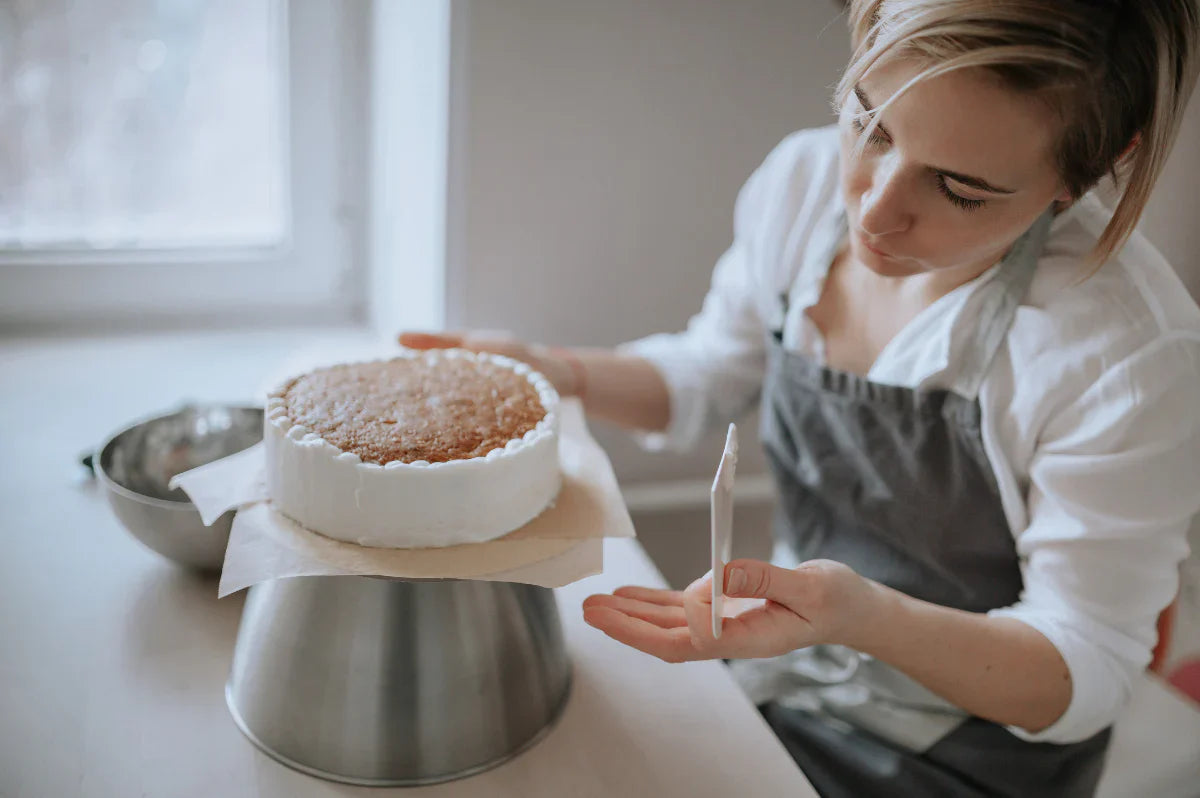 A baker finishing a cake